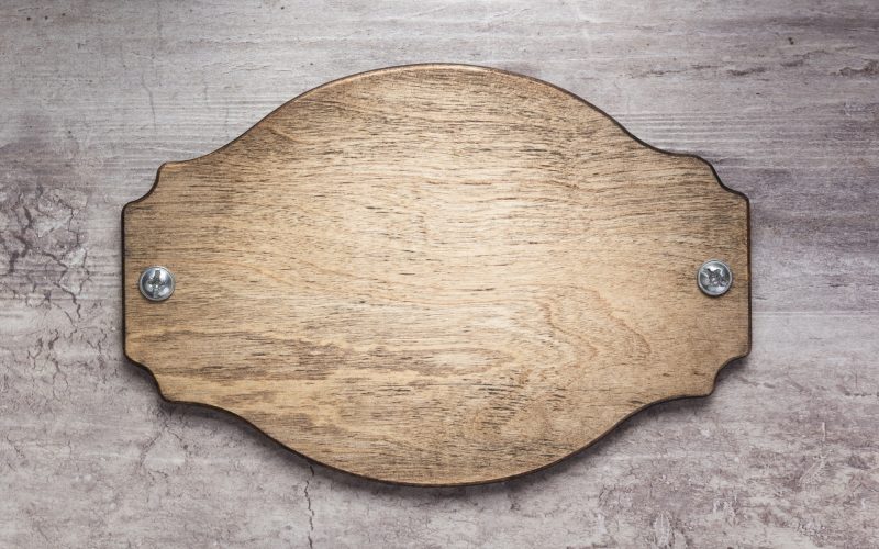 wooden nameplate or wall sign at concrete background wooden nameplate or wall sign at concrete background